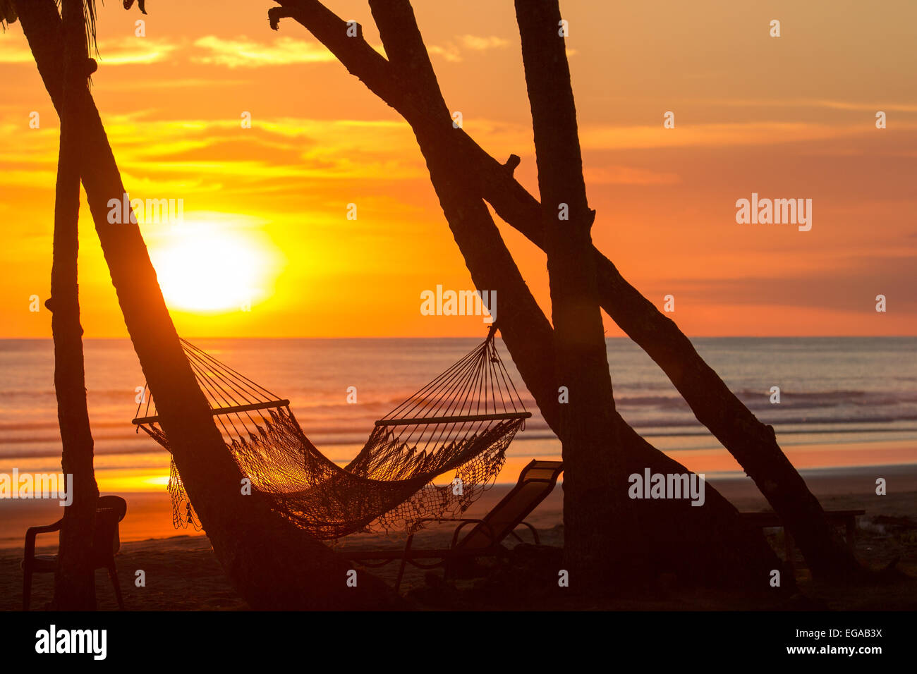 Sunset on beach with hammock Stock Photo