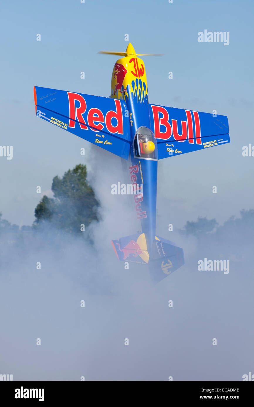 Red Bull RC stunt plane with smoke at air display Stock Photo - Alamy
