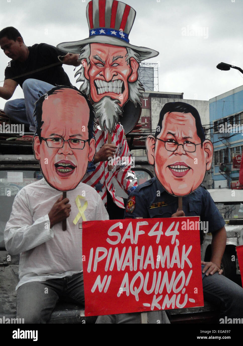 Activists wear cut-outs of President Benigno Aquino III, resigned police chief Alan Purisima, and Uncle Sam, as they call on Aquino to resign, during a rally at the Plaza Miranda in Quiapo. Activists held a 'People's Hearing' on the Mamasapano incident, where they reported on the findings of a fact-finding mission about the incident, where 44 policemen, 18 Muslim rebels, and 7 civilians were killed in a botched anti-terror operation that reportedly killed Malaysian bombmaker Zulkifli 'Marwan' Abdhir. The placard reads as, ' (President) Aquino put the SAF 44 in harms way!' (Photo by Richard Ja Stock Photo