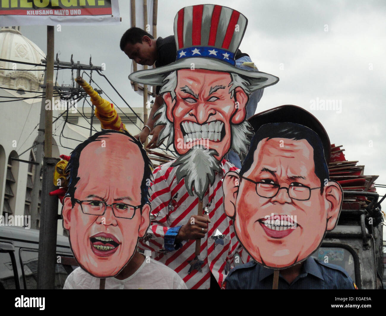 Activists wear cut-outs of President Benigno Aquino III, resigned police chief Alan Purisima, and the proverbial Uncle Sam, as they call on Aquino to resign, during a rally at the Plaza Miranda in Quiapo. Activists held a 'People's Hearing' on the Mamasapano incident, where they reported on the findings of a fact-finding mission about the incident, where 44 policemen, 18 Muslim rebels, and 7 civilians were killed in a botched anti-terror operation that reportedly killed Malaysian bombmaker Zulkifli 'Marwan' Abdhir. © Richard James Mendoza/Pacific Press/Alamy Live News Stock Photo