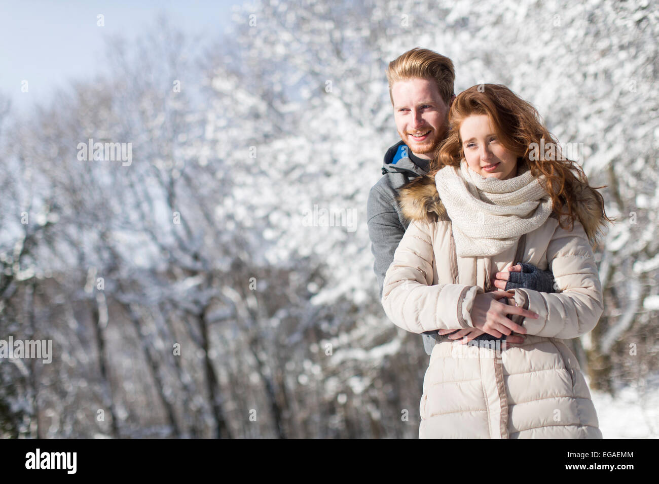 Young couple at winter forest Stock Photo - Alamy