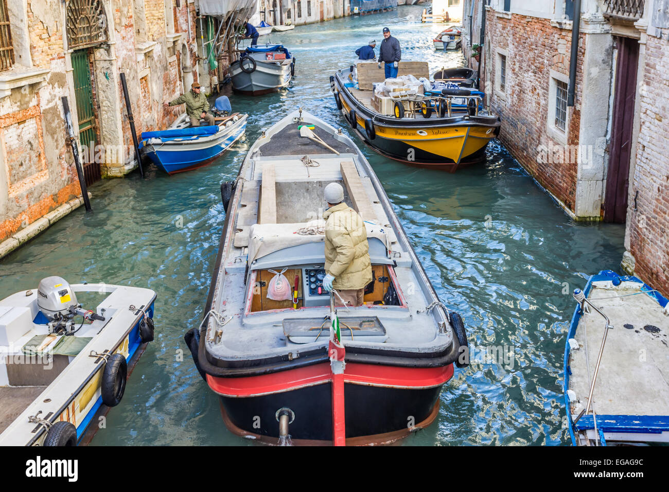 Two workboats on congested canal in Venice Stock Photo