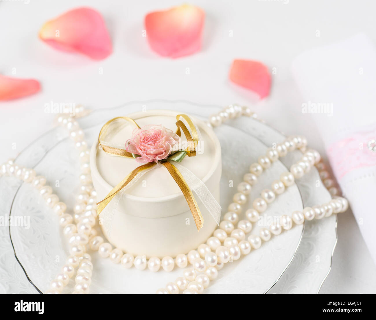 Wedding table accessories with rose petals and pearls Stock Photo Alamy