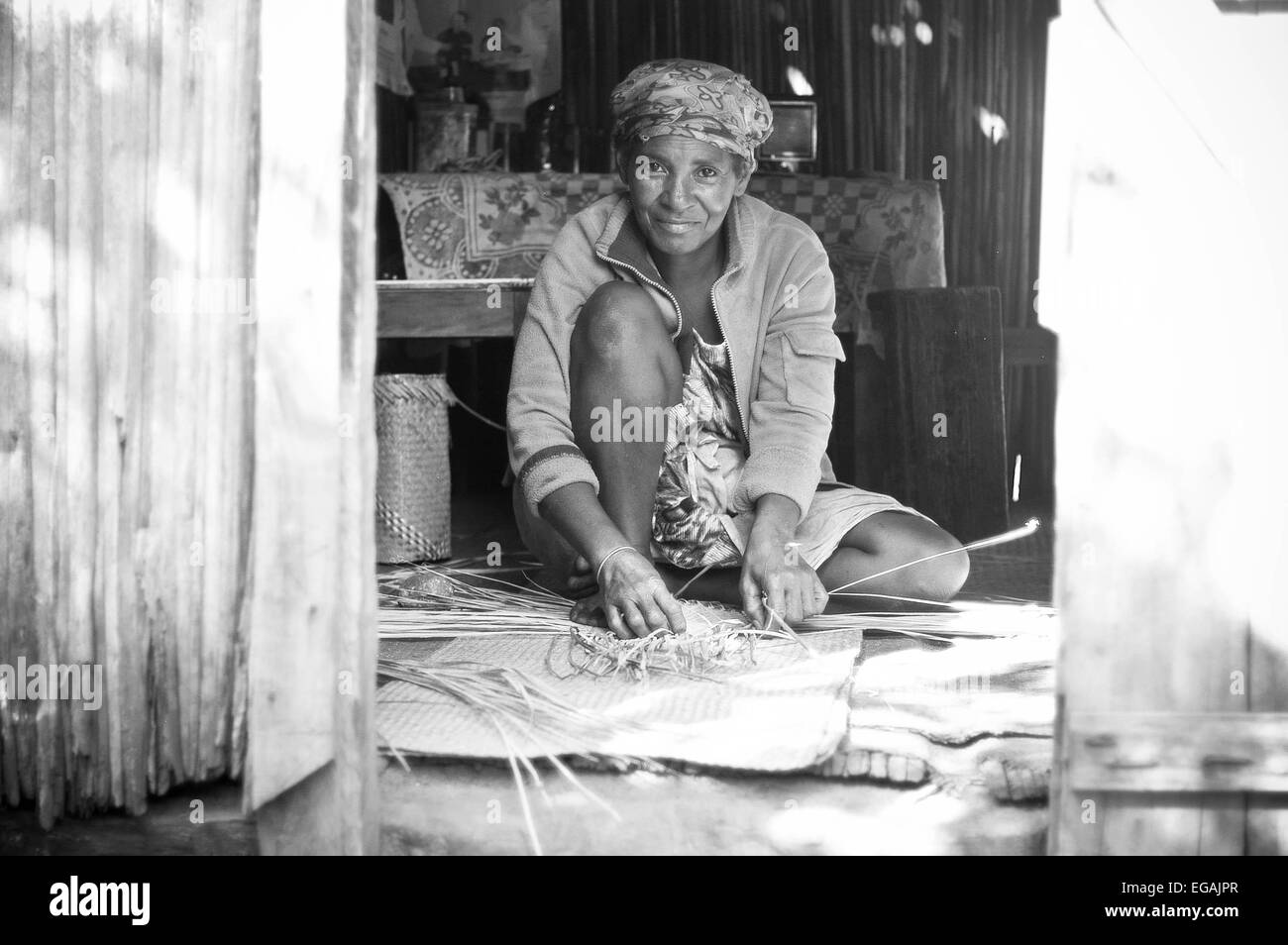 A  woman weaves in her house Stock Photo