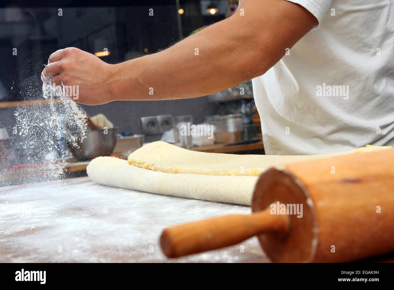 Baker poured flour on the table for rolling dough Stock Photo Alamy
