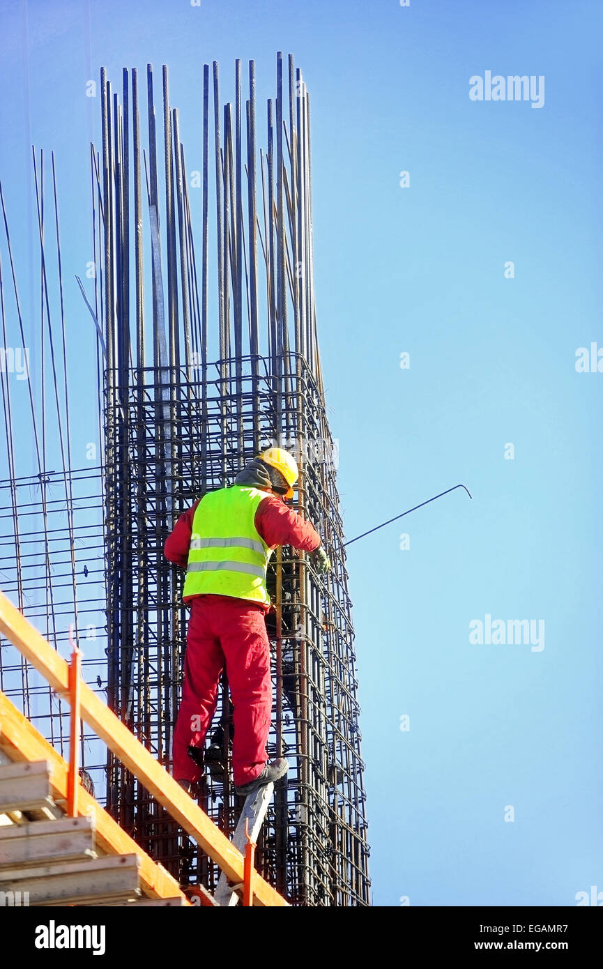 Construction worker knitting steel rods reinforce for concrete pouring Stock Photo