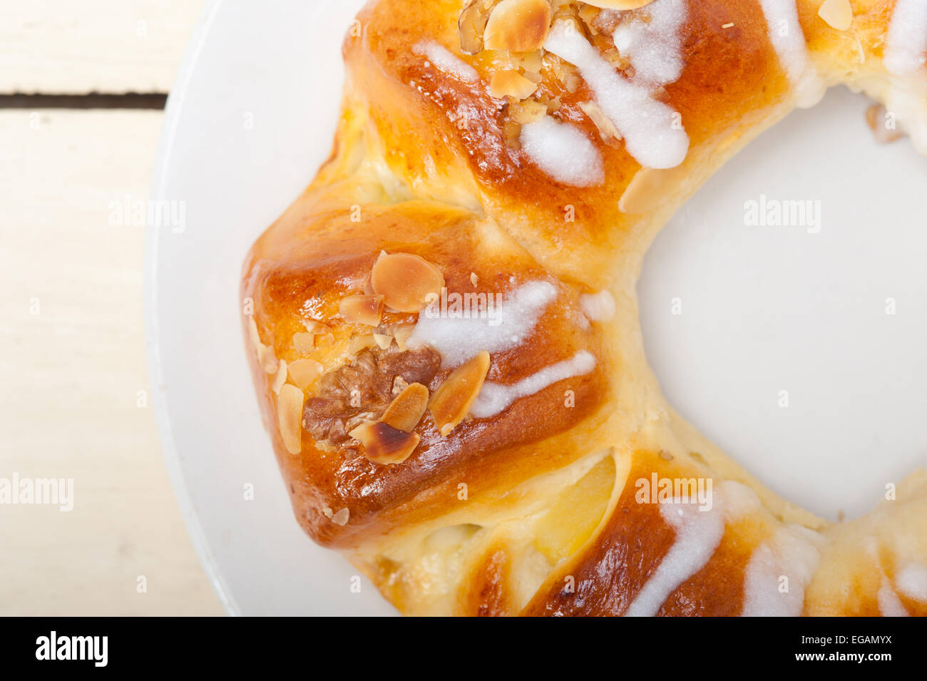 fresh home baked sweet bread donut cake with almonds and icing sugar on