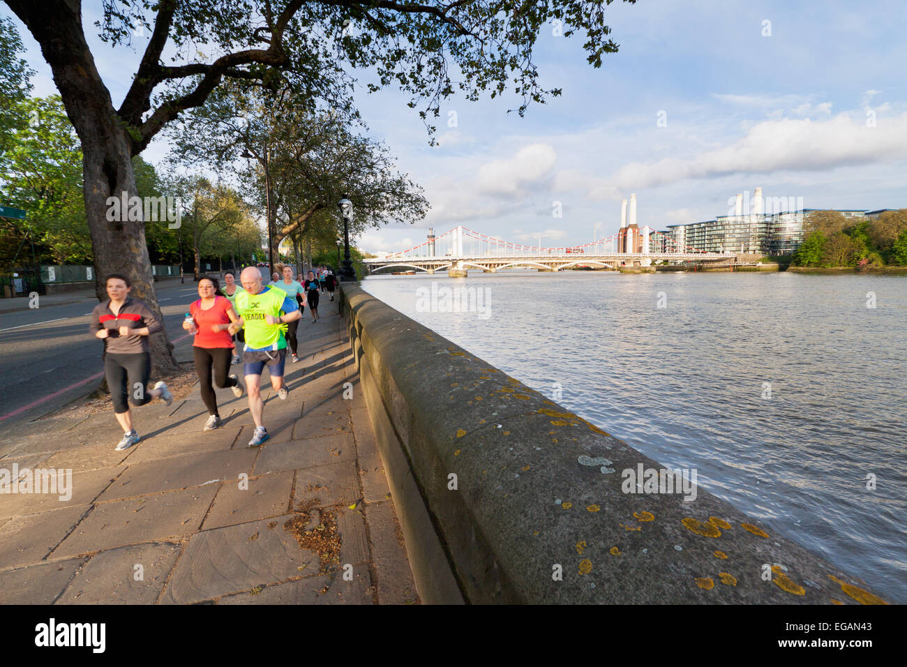 London joggers run along the Chelsea Embankment, London, England Stock