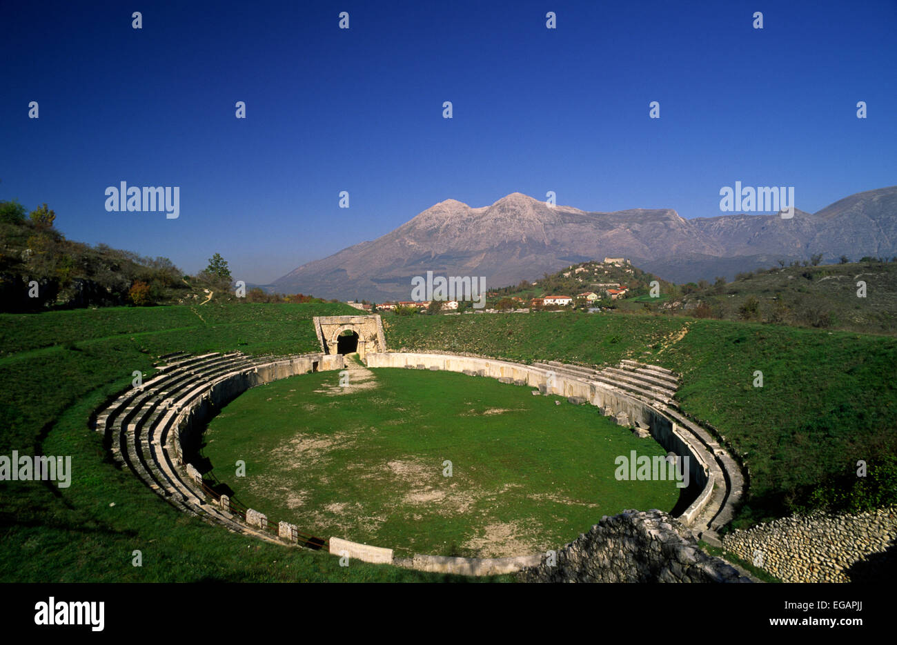 Italy, Abruzzo, Alba Fucens roman amphitheatre ruins and Mount Velino Stock Photo