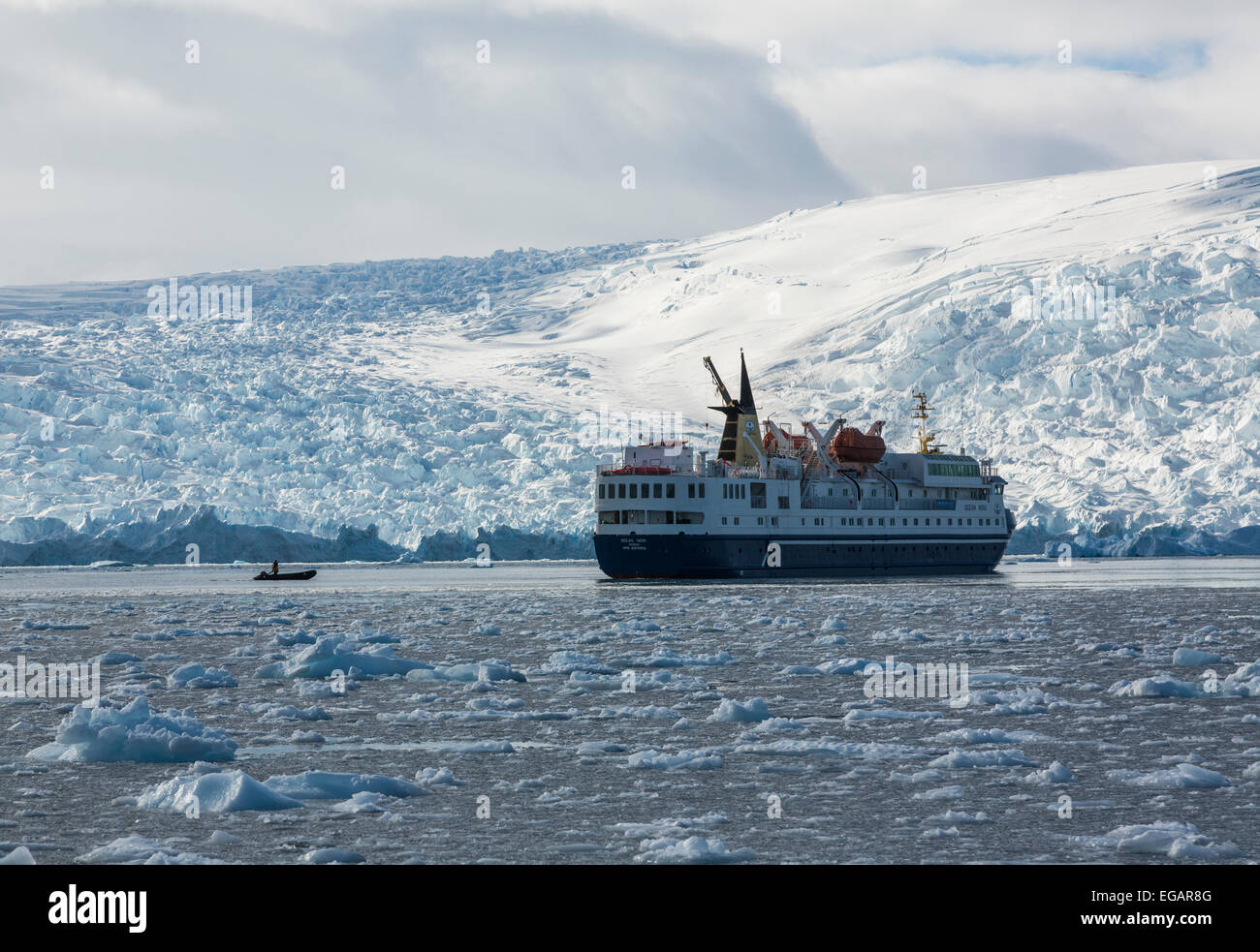 Ocean Nova cruise ship in front of glacier,Cierva Cove, Antarctica Stock Photo