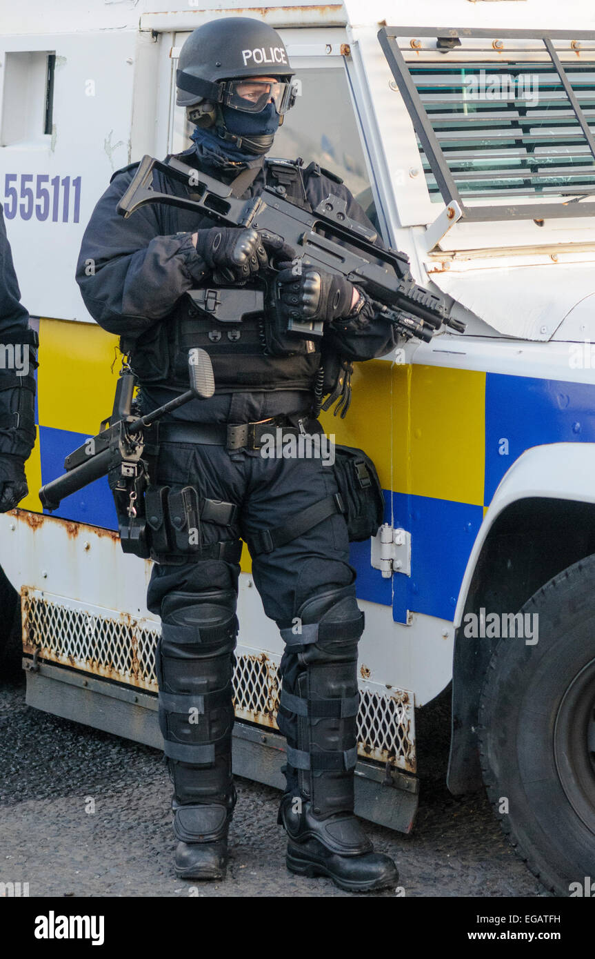 Police officer dressed in ballistic uniform holds a Heckler and Koch G36 machine gun. Stock Photo