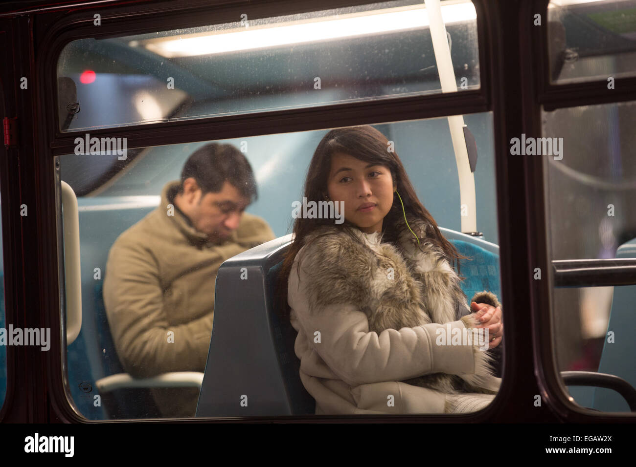 Passengers on a London bus on Regent Street, London, England on a damp winter evening Stock Photo
