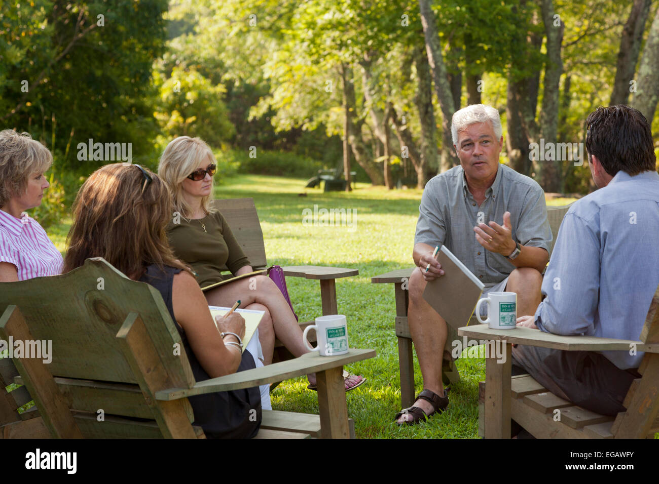 Group of business people meeting outside on corporate retreat Stock Photo
