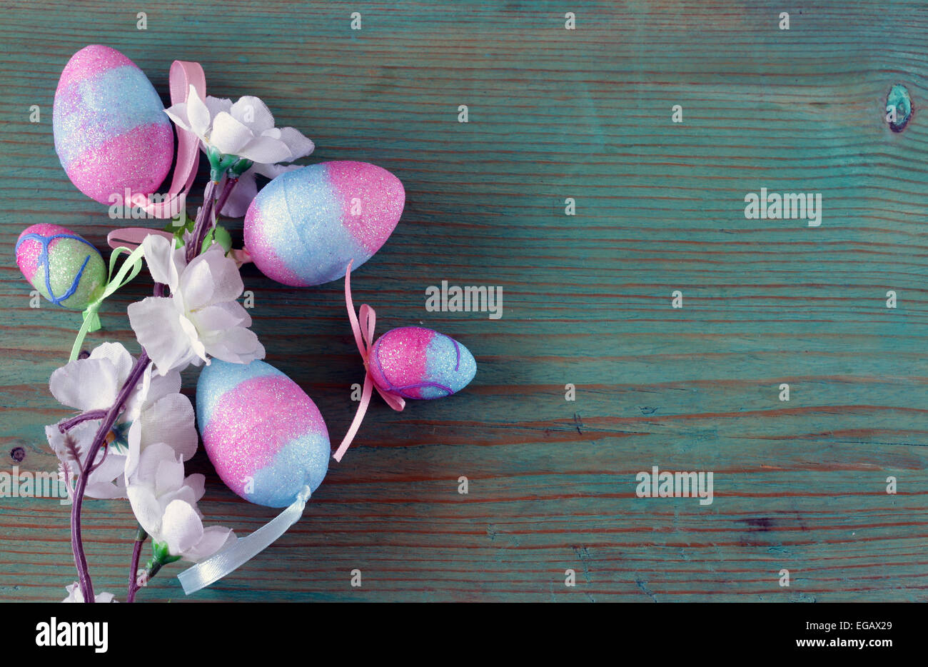 Colorful decorative easter eggs and branch with spring flowers on the ...
