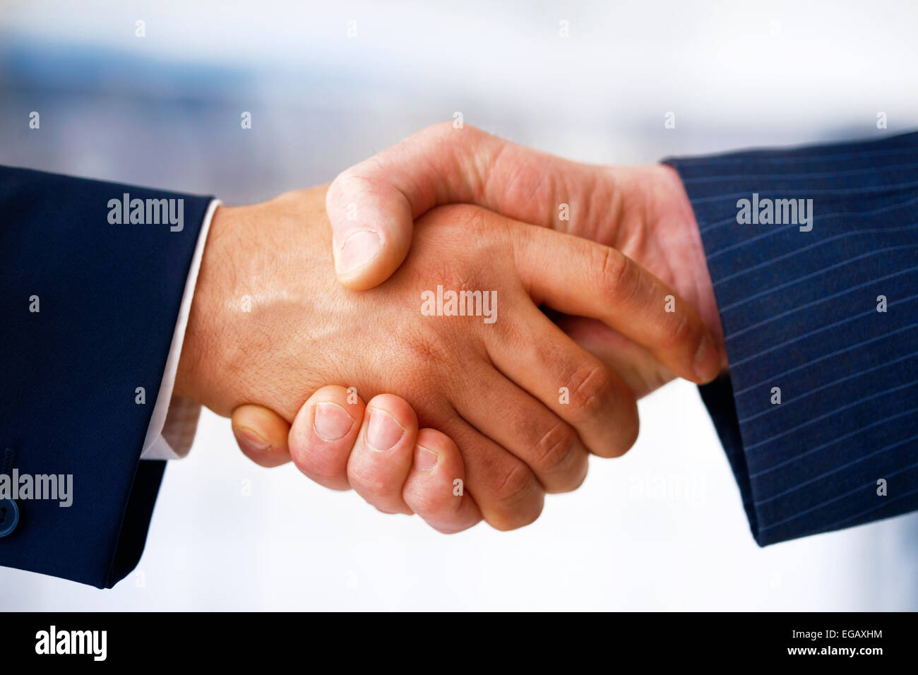 Closeup picture of businesspeople shaking hands, making an agreement. Stock Photo