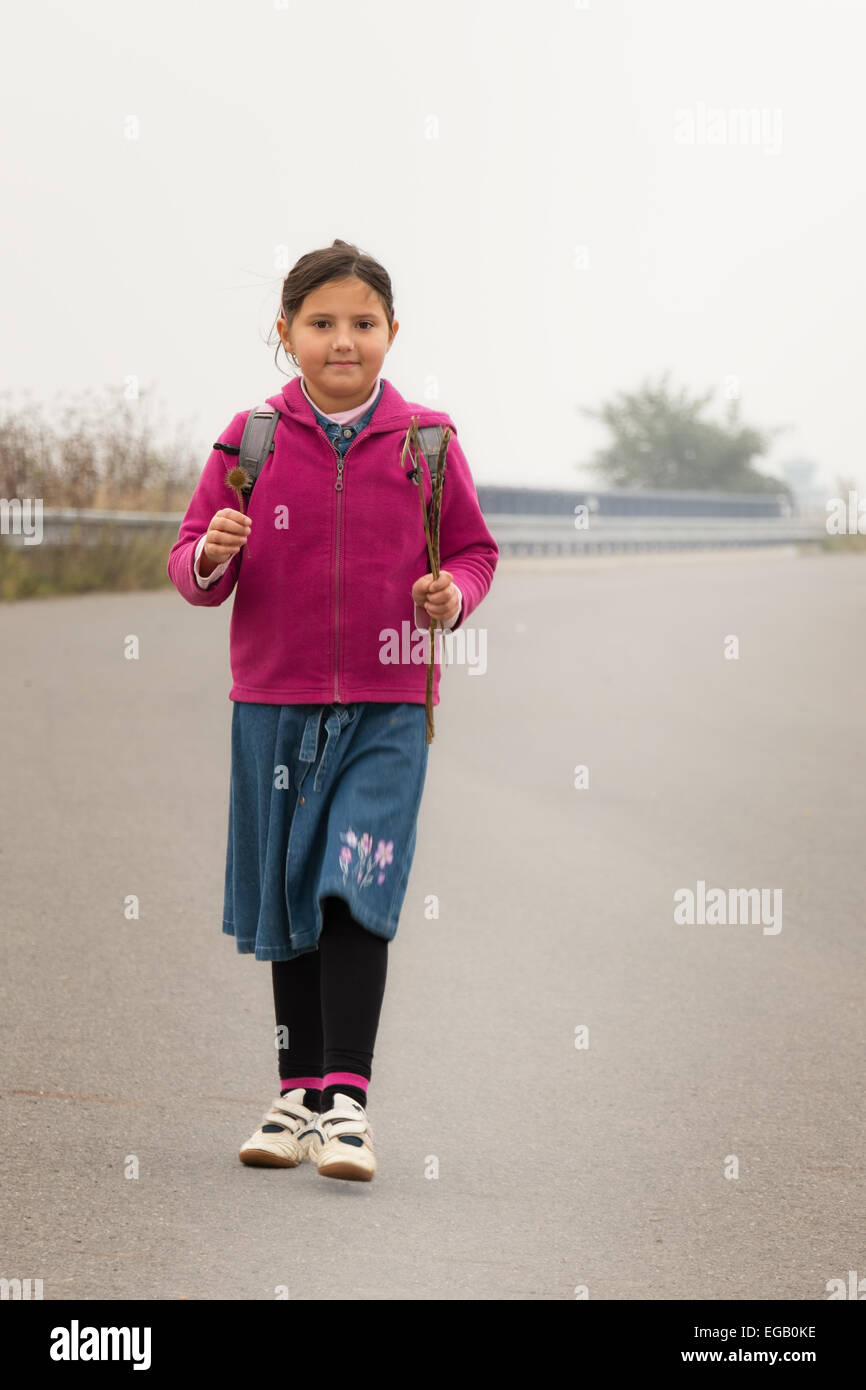 Autumn portrait of a child, little girl, on her way. Stock Photo