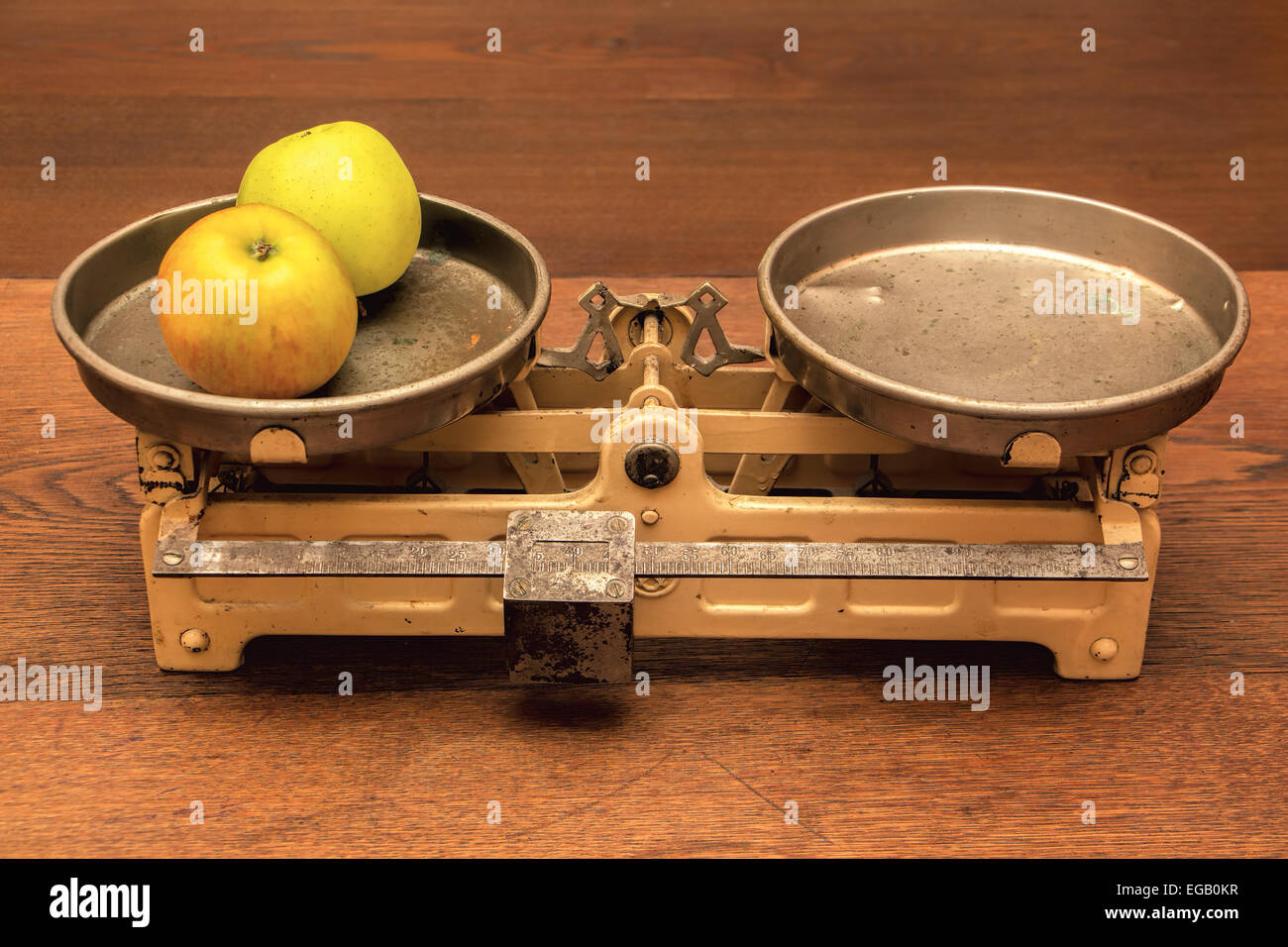 Vintage kitchen scales on wooden table. Stock Photo