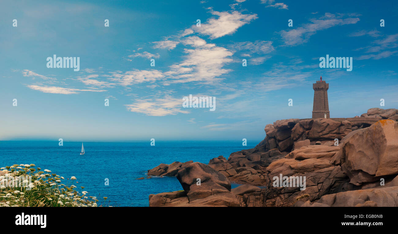 Men ruz lighthouse in Brittany France between Ploumanach and Perros Guirec pink granit coast landscape, Blue sky Stock Photo