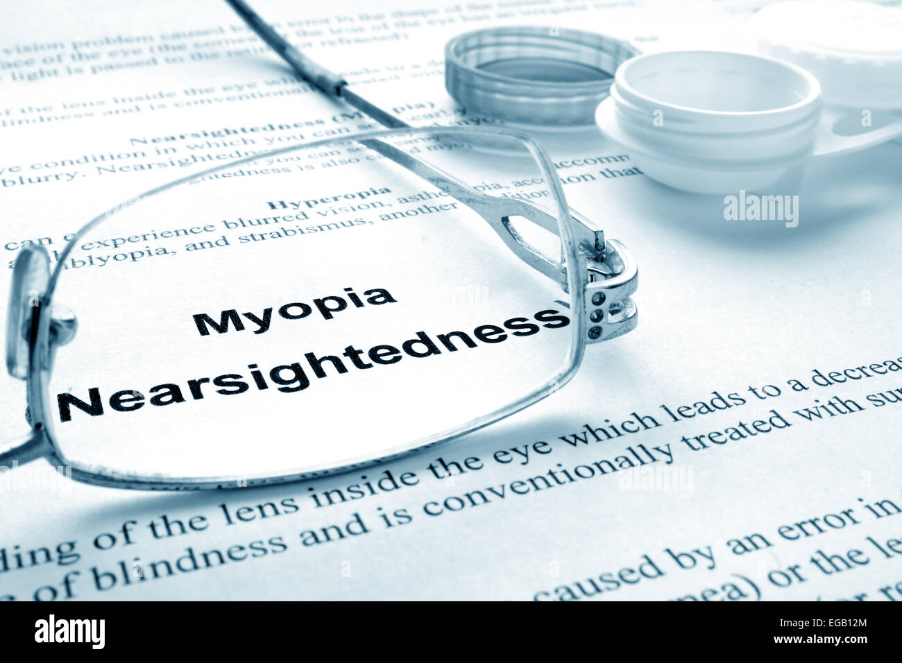 Paper with words  myopia (nearsightedness), glasses and container for lenses. Eye disorders. Selective focus. Stock Photo