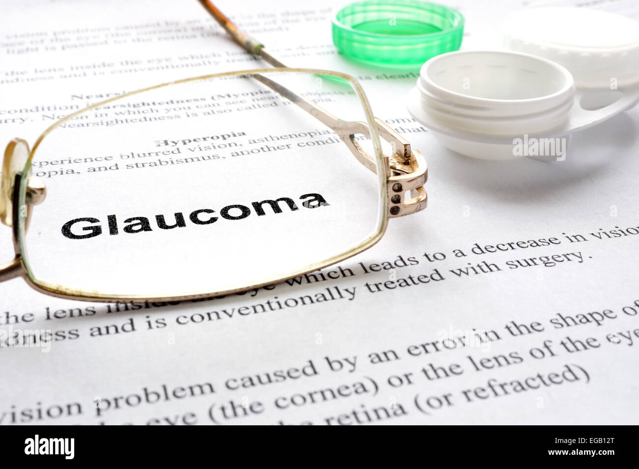 Paper with words  glaucoma, glasses and container for lenses. Eye disorders. Selective focus. Stock Photo