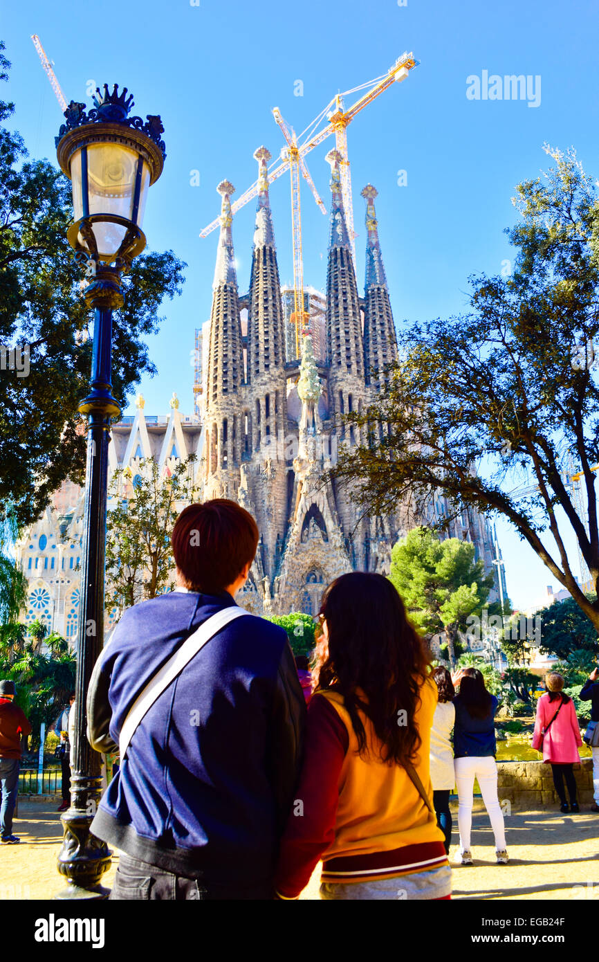 Couple contemplating Sagrada Familia. Barcelona, Catalonia, Spain. Stock Photo