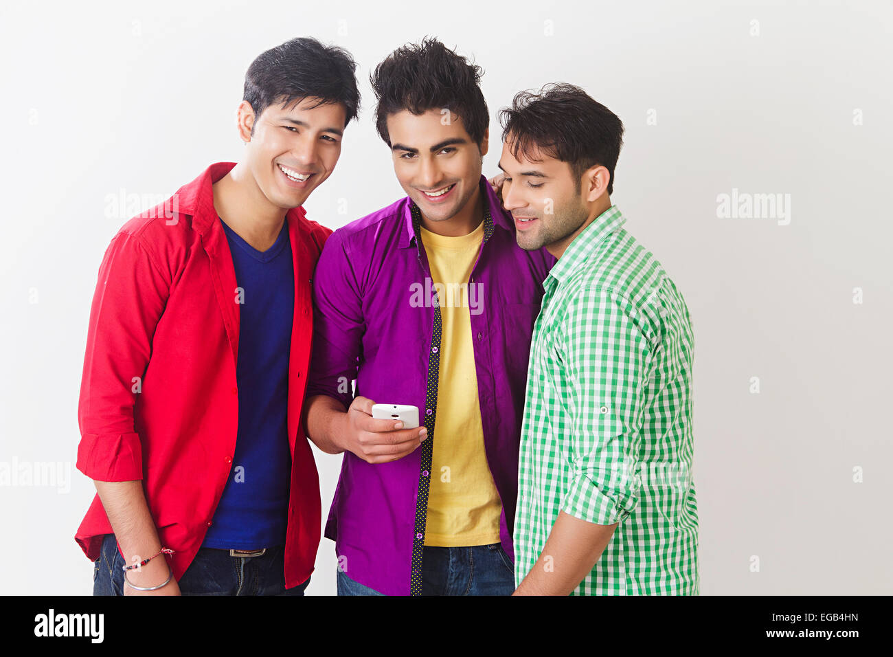 3 indian College friends chatting phone Stock Photo