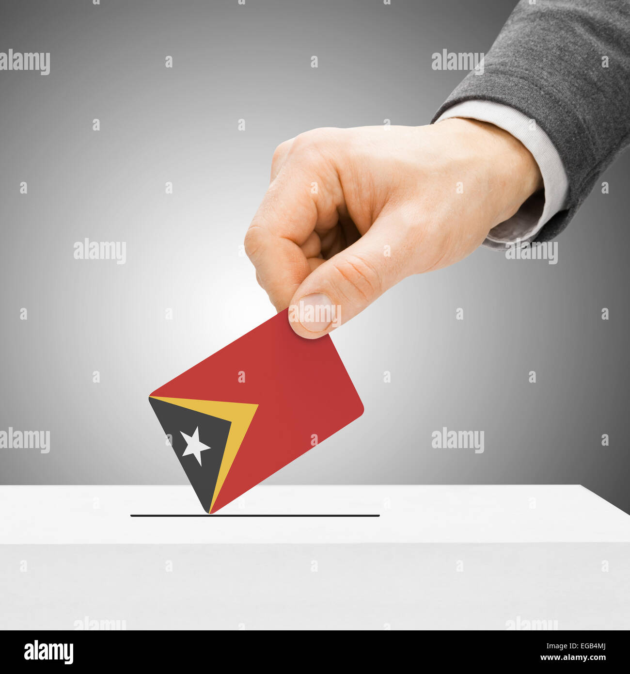 Voting concept - Male inserting flag into ballot box - East Timor Stock ...