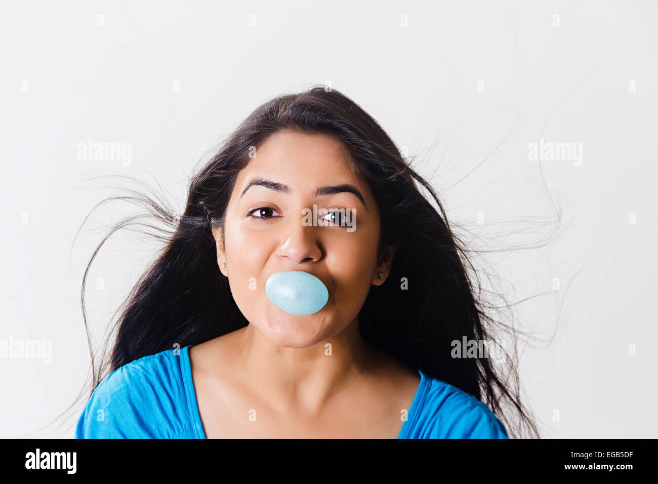 1 indian Girl Blowing  Bubble Gum Stock Photo