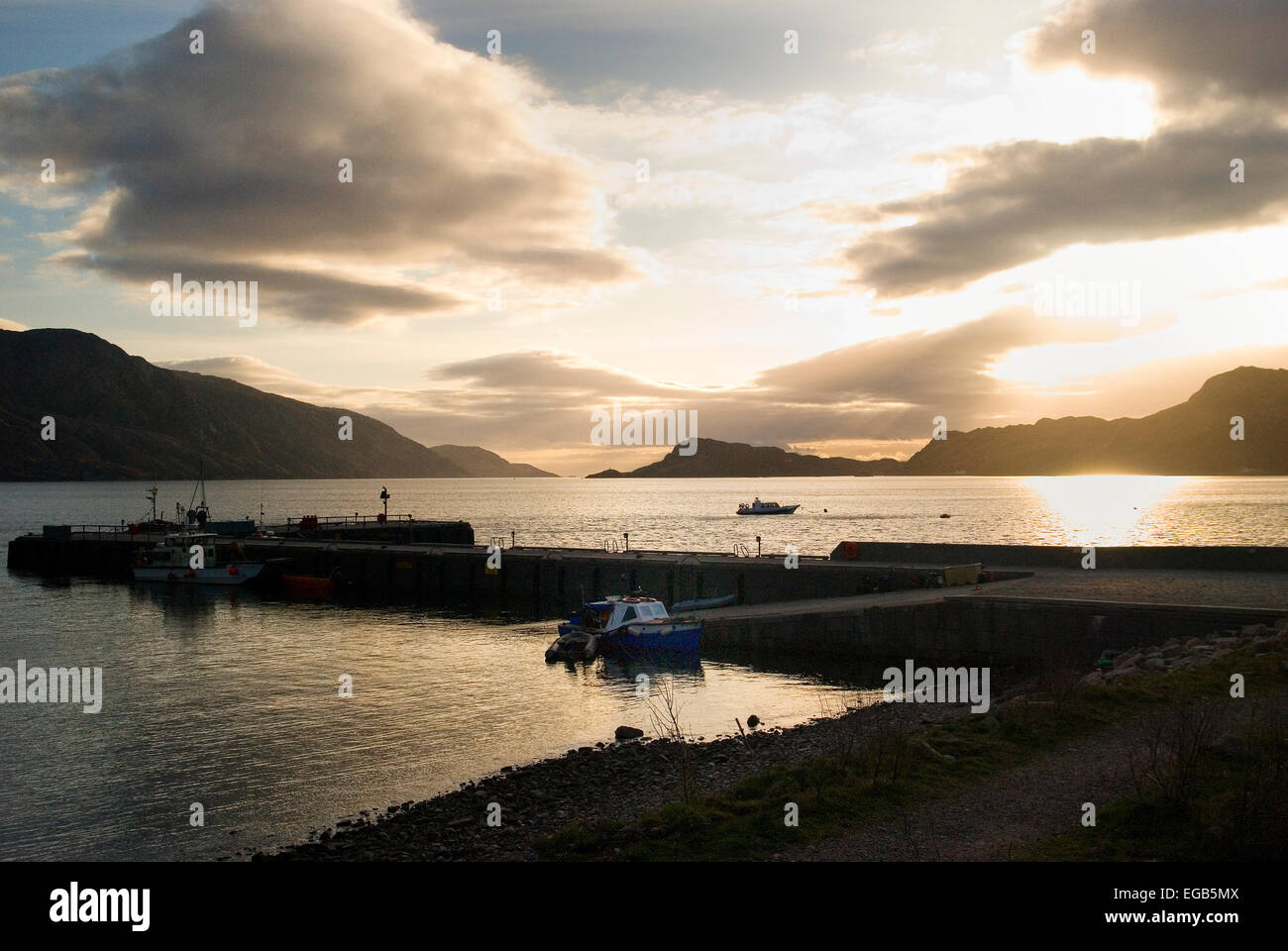 Sunset over Inverie Pier, Inverie Bay in Knoydart Peninsula - the last great wilderness in Great Britain Stock Photo