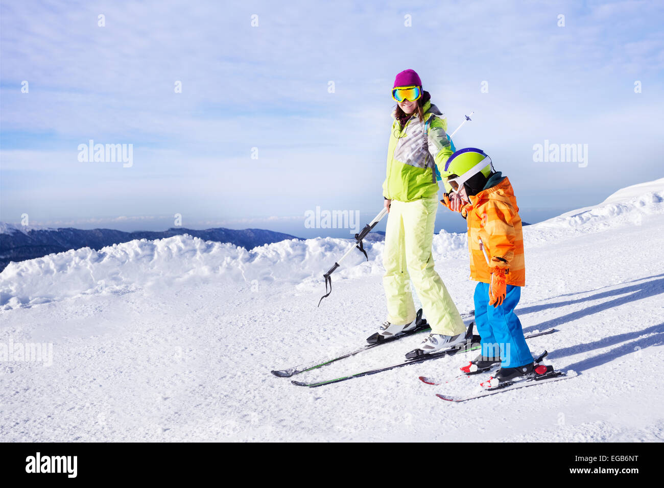 Teaching little boy to ski going holding hand Stock Photo