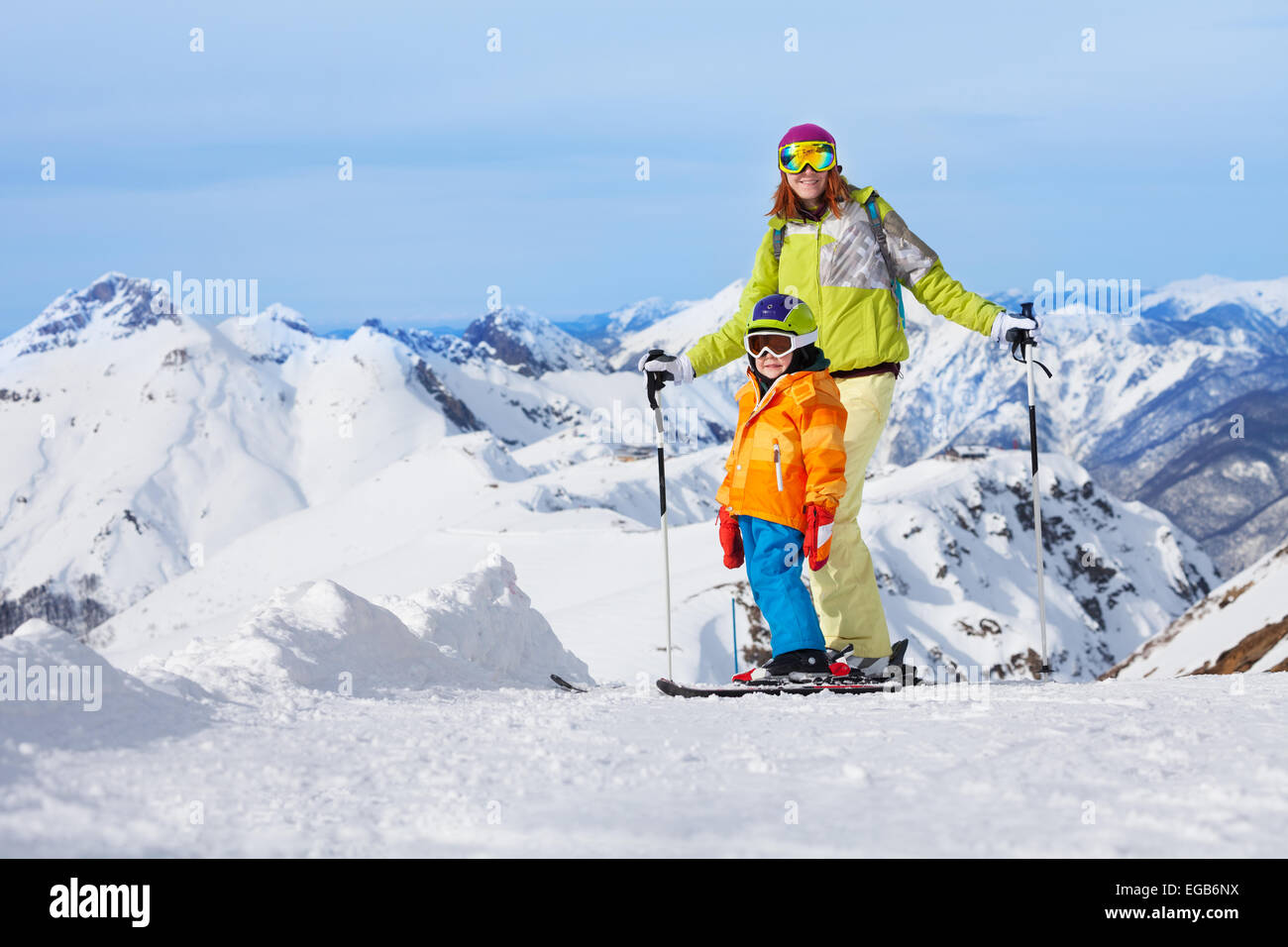 Mother with boy skiers in mountains Stock Photo
