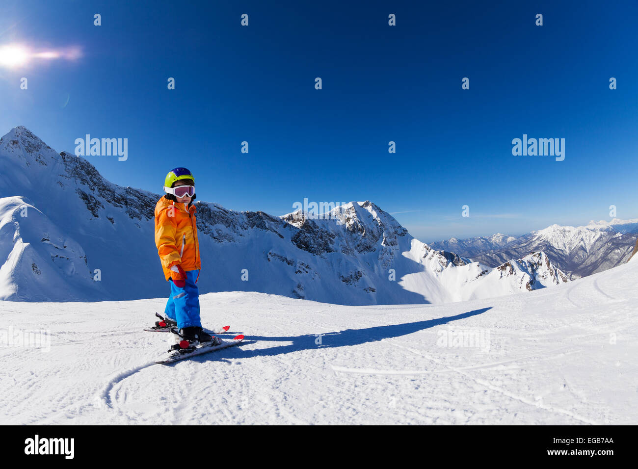 Boy skiing in sunny weather with mountain view Stock Photo - Alamy