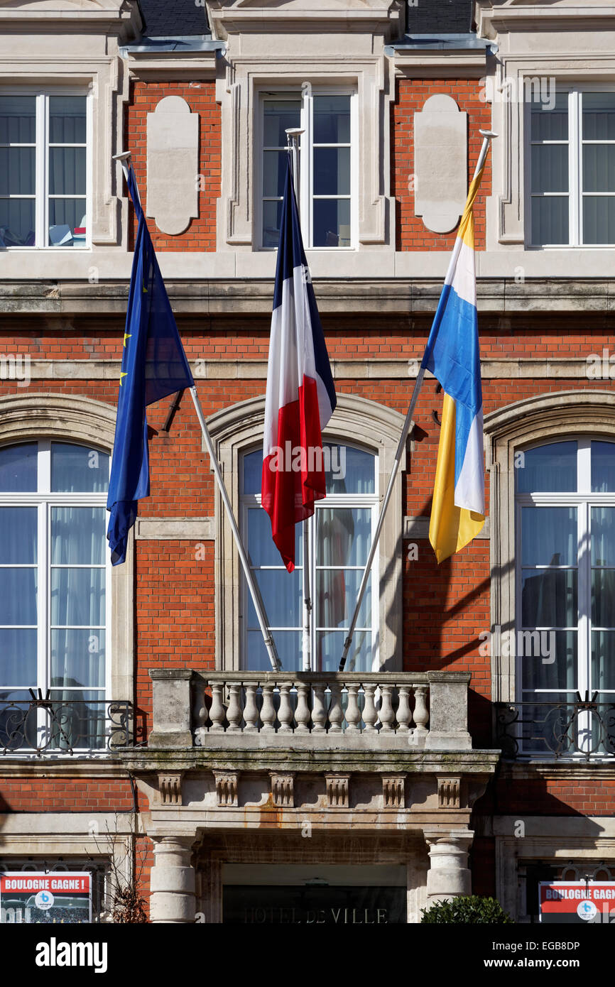 Flags flying outside the Hotel de Ville, in the fortified old town of Boulogne sur Mer Stock Photo