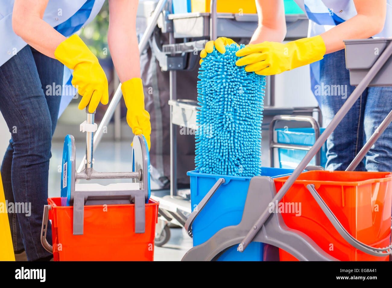 Cleaning ladies mopping floor, close up on hands and tools Stock Photo