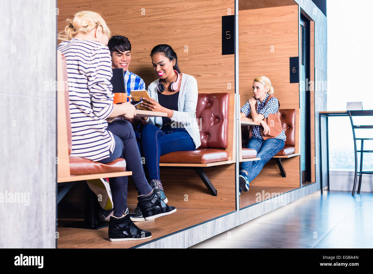 Creative business people in coworking space having meetings in cubicle offices Stock Photo