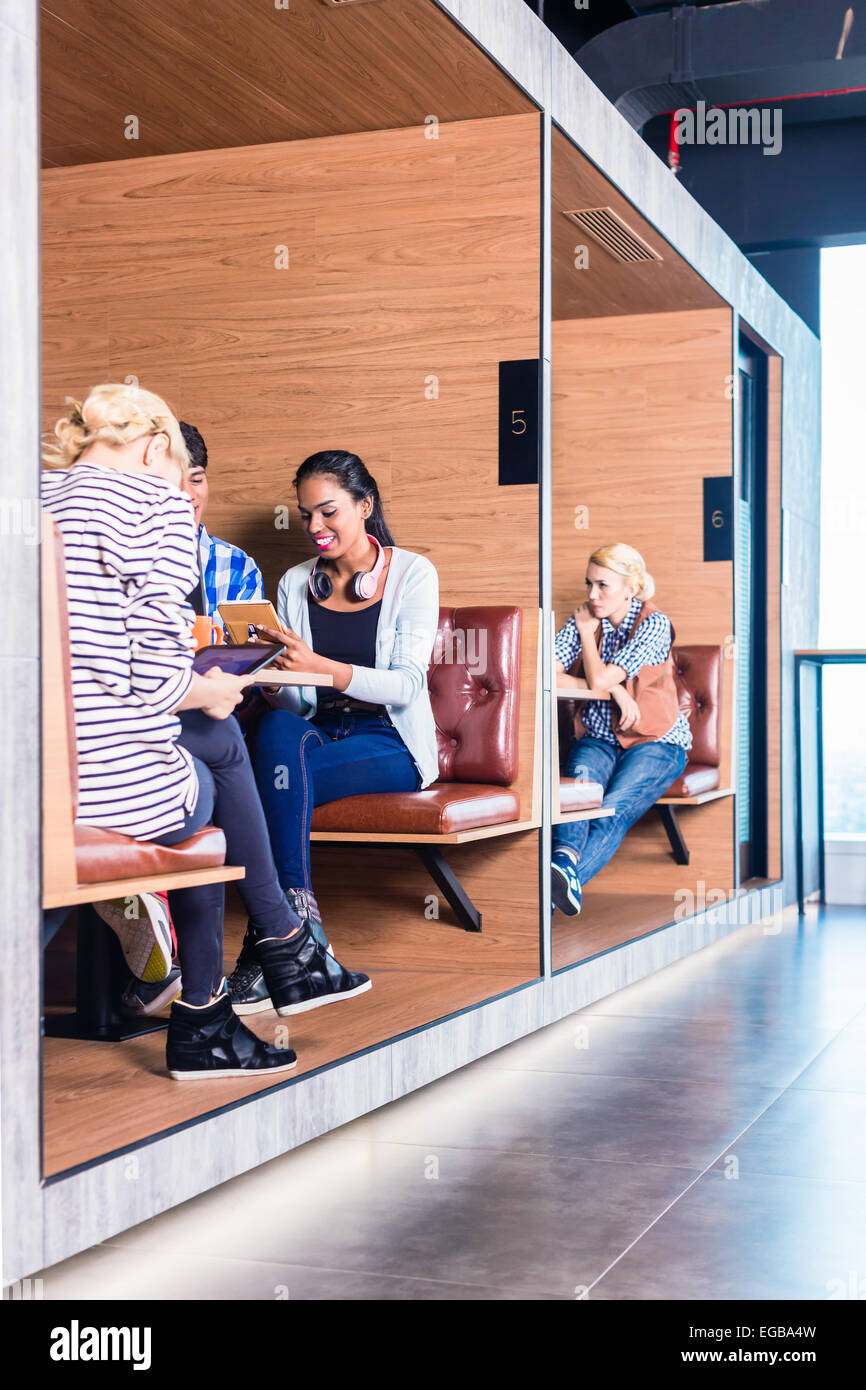 Creative business people in coworking space having meetings in cubicle offices Stock Photo