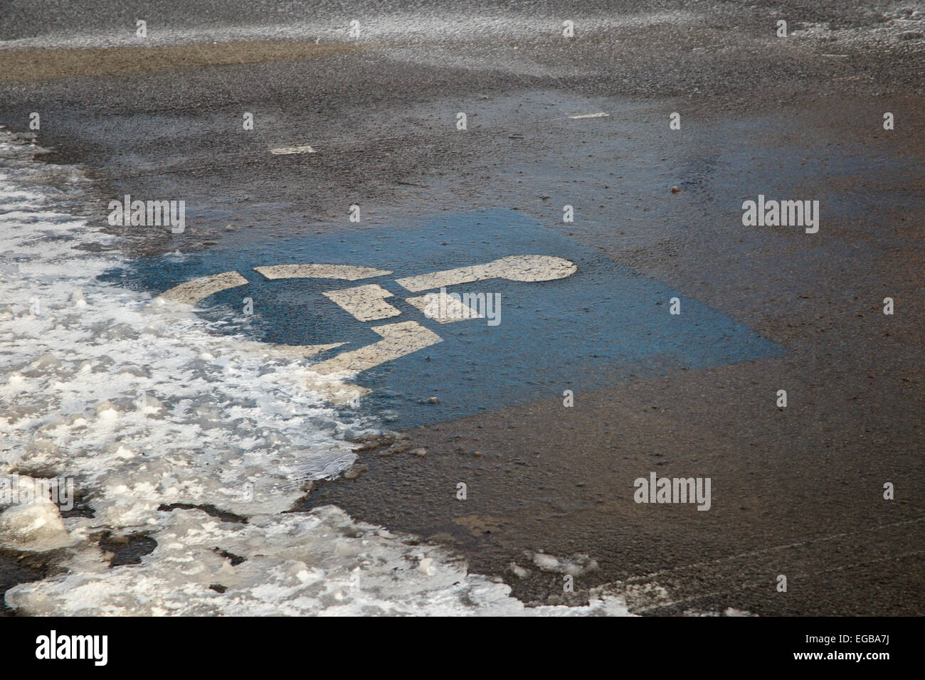 Handicap only parking symbol on snowy parking space. Stock Photo