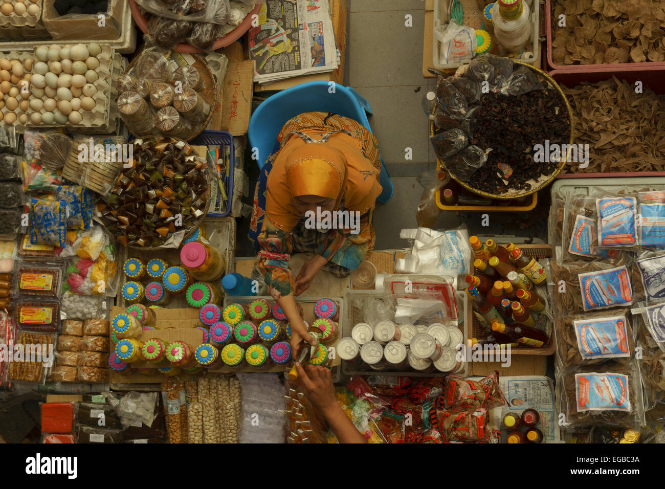 A local seller doing her daily transaction of selling the goods for visitors at Pasar Besar Siti Khadijah. Stock Photo