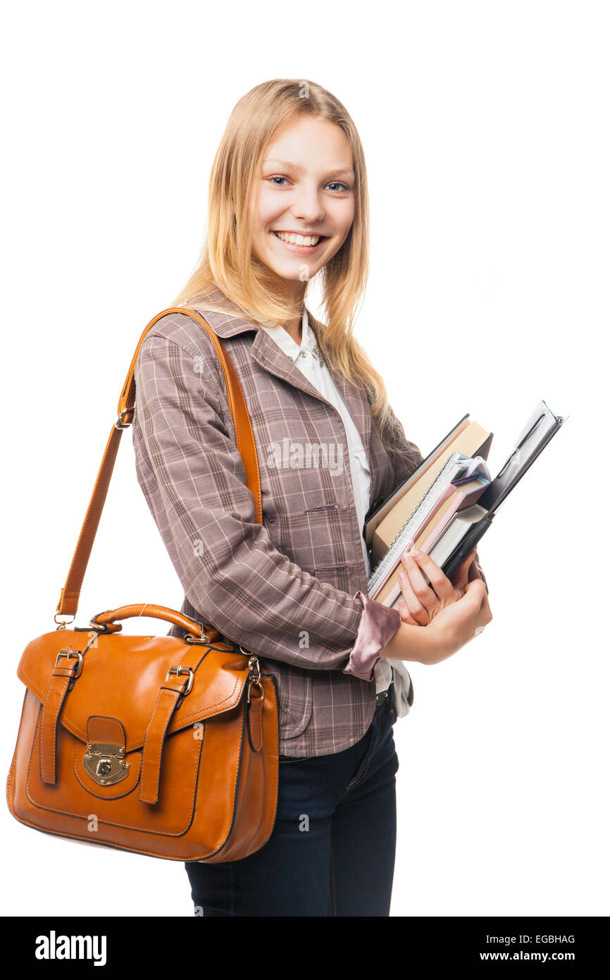 Smiling young girl standing with bag and books Stock Photo - Alamy