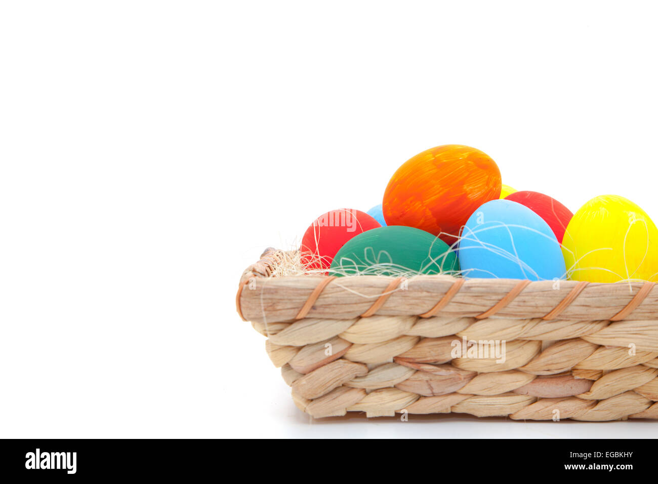 Easter eggs in basket on white background Stock Photo - Alamy