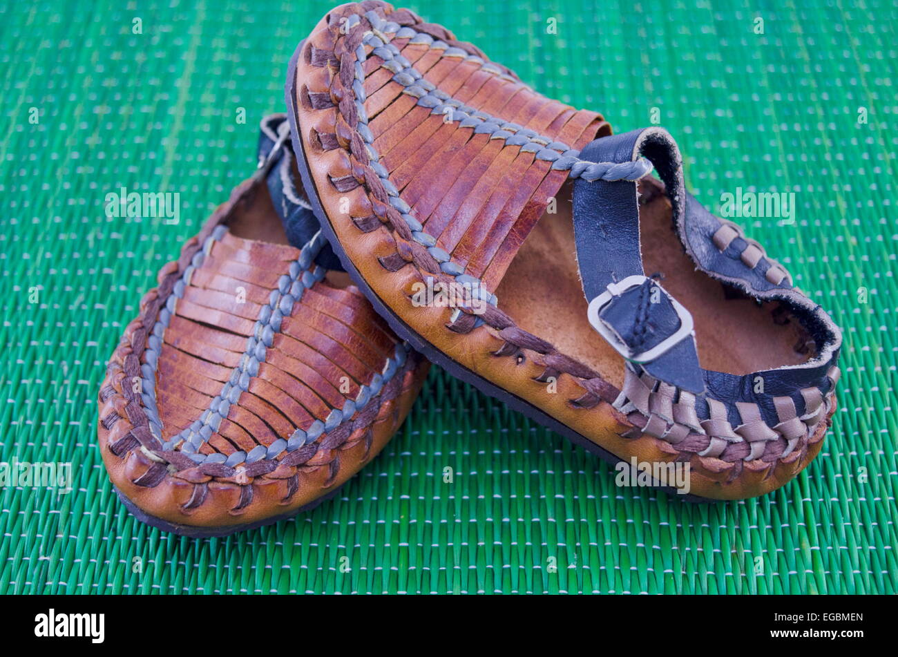 Serbian peasant shoe on green tablecloth Stock Photo