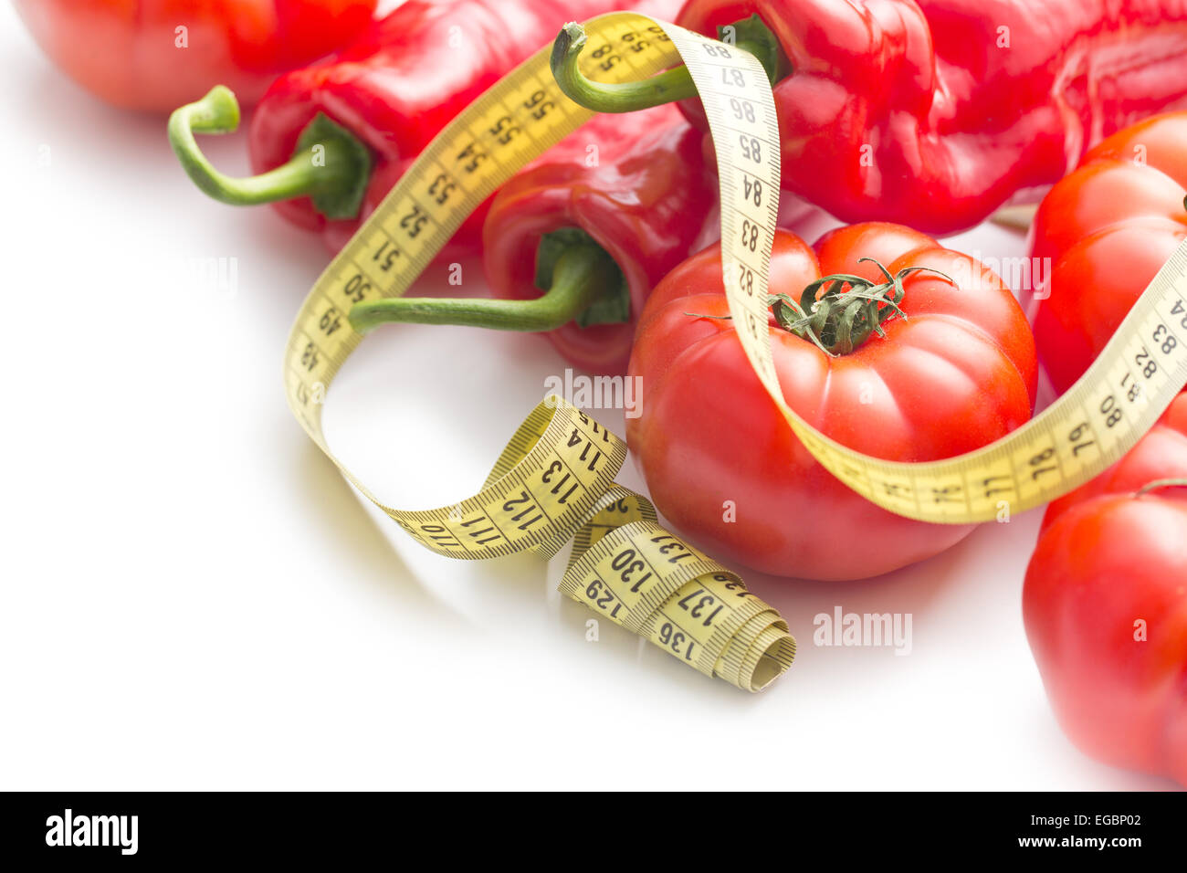 Diet concept. Peppers and tomatoes on white background. Stock Photo