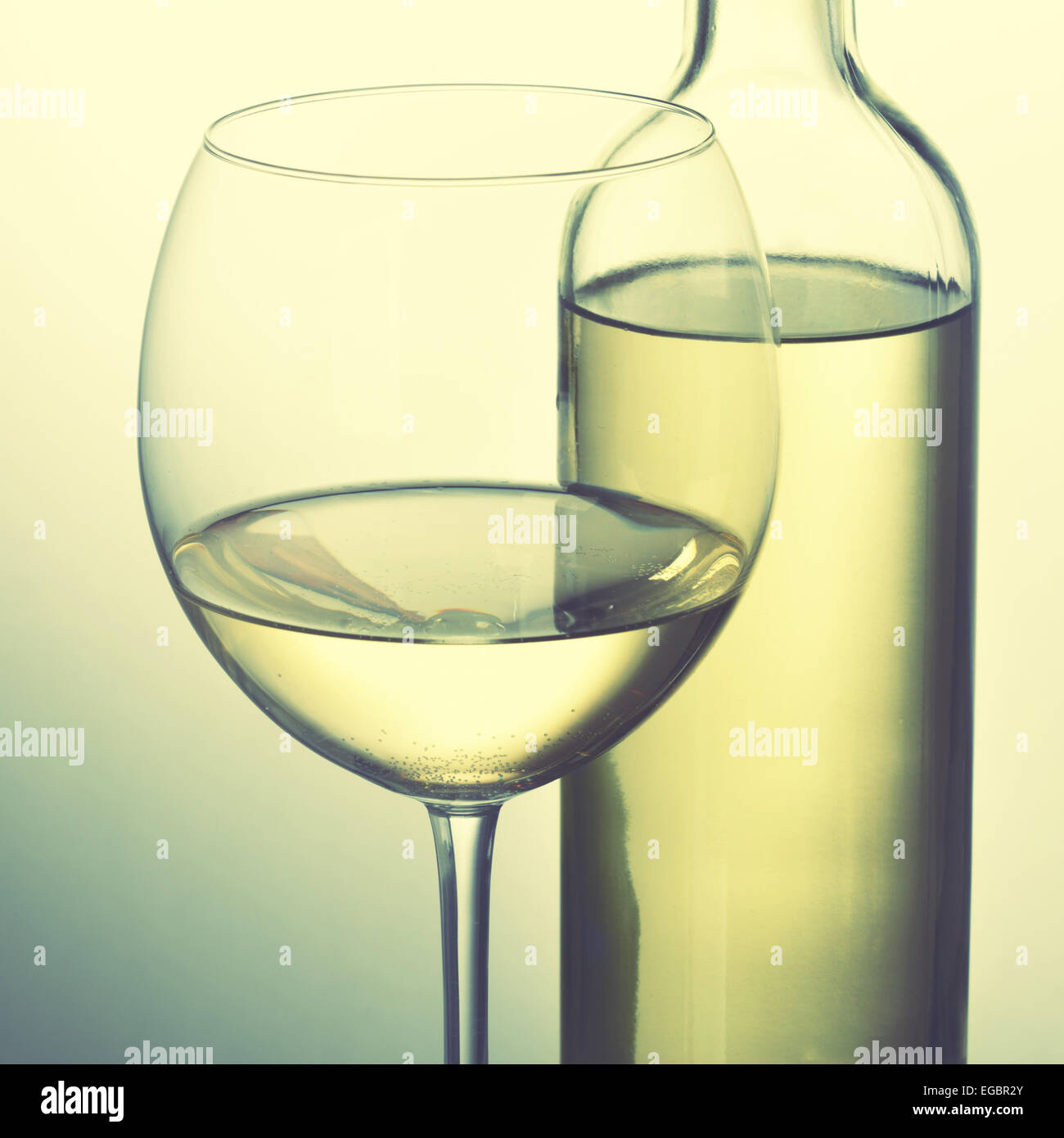 Bottle of white wine and glass. Retro style image Stock Photo