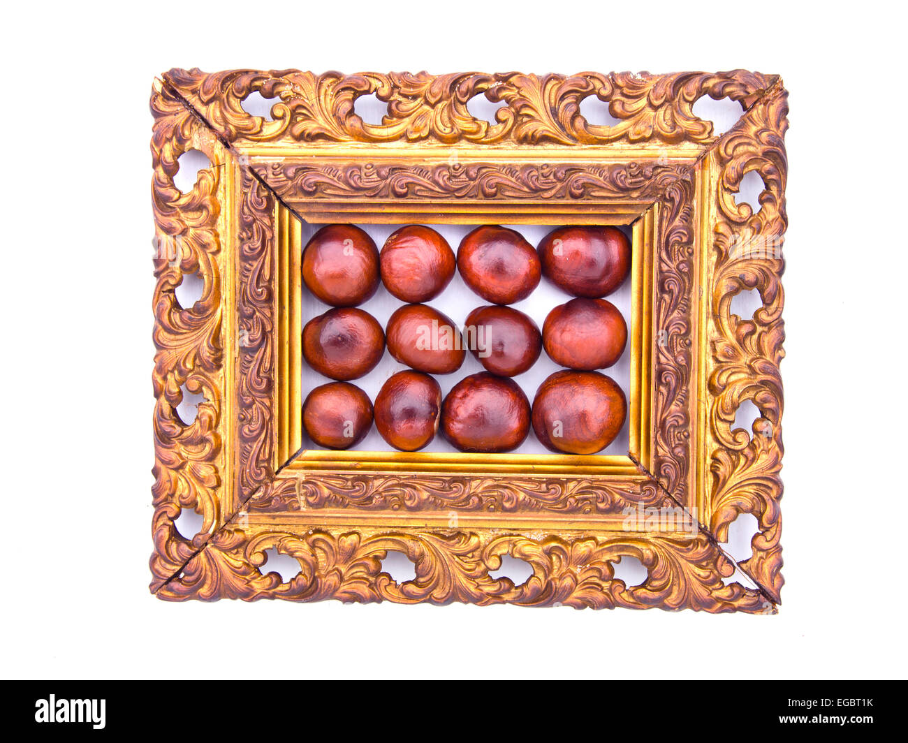 conker fruits in antique ornate picture frame isolated on white Stock ...