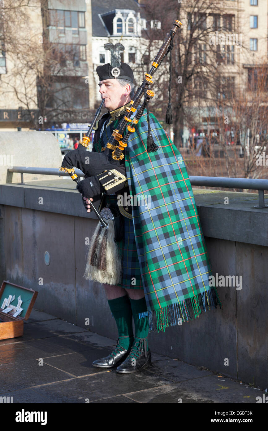 A Scottish bagpiper playing on the streets of Edinburgh, Scotland Stock Photo