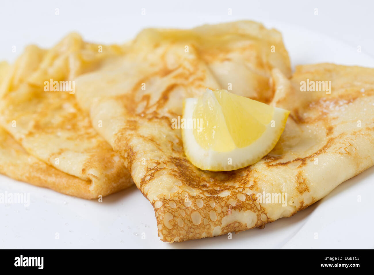 Pancakes English-style, with sugar and lemon, most traditionally served on Shrove Tuesday aka 'pancake day', Stock Photo