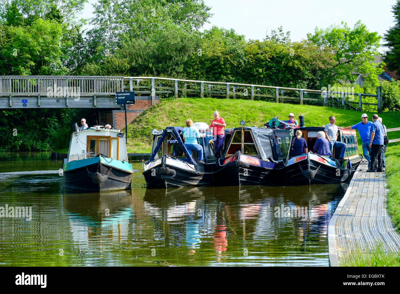 Four canal boats and their owners meet Stock Photo