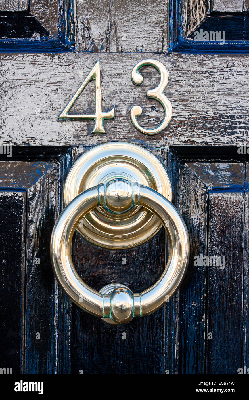 England, Sandwich. Front door, street Number 43 with door knocker underneath. Black wooden door, with number in metal Stock Photo