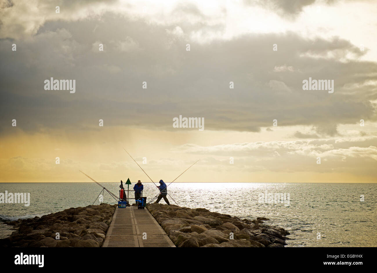 Fishermen trying their luck in the sea at Sandbanks, Near Poole, Dorset, England UK Stock Photo