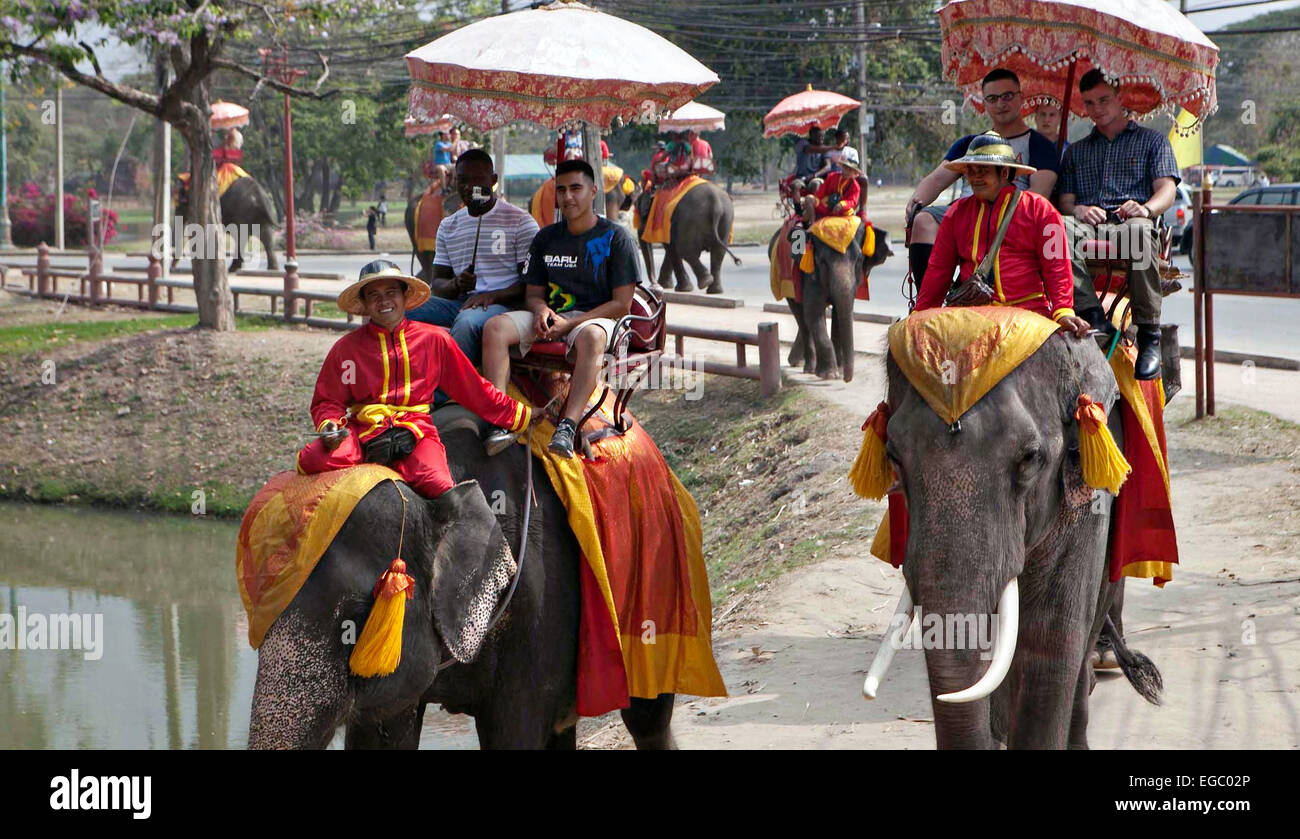 US Marines in civilian clothing enjoy a day out riding elephants during a tour of temples following joint exercise Cobra Gold with the Royal Thai Armed Forces February 15, 2015 in Ayutthaya, Thailand. Stock Photo